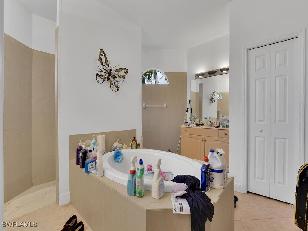 8123 Sandpiper Road Fort Myers, FL 33967 - Photo 13 of 23 a bathroom with a tub and sink