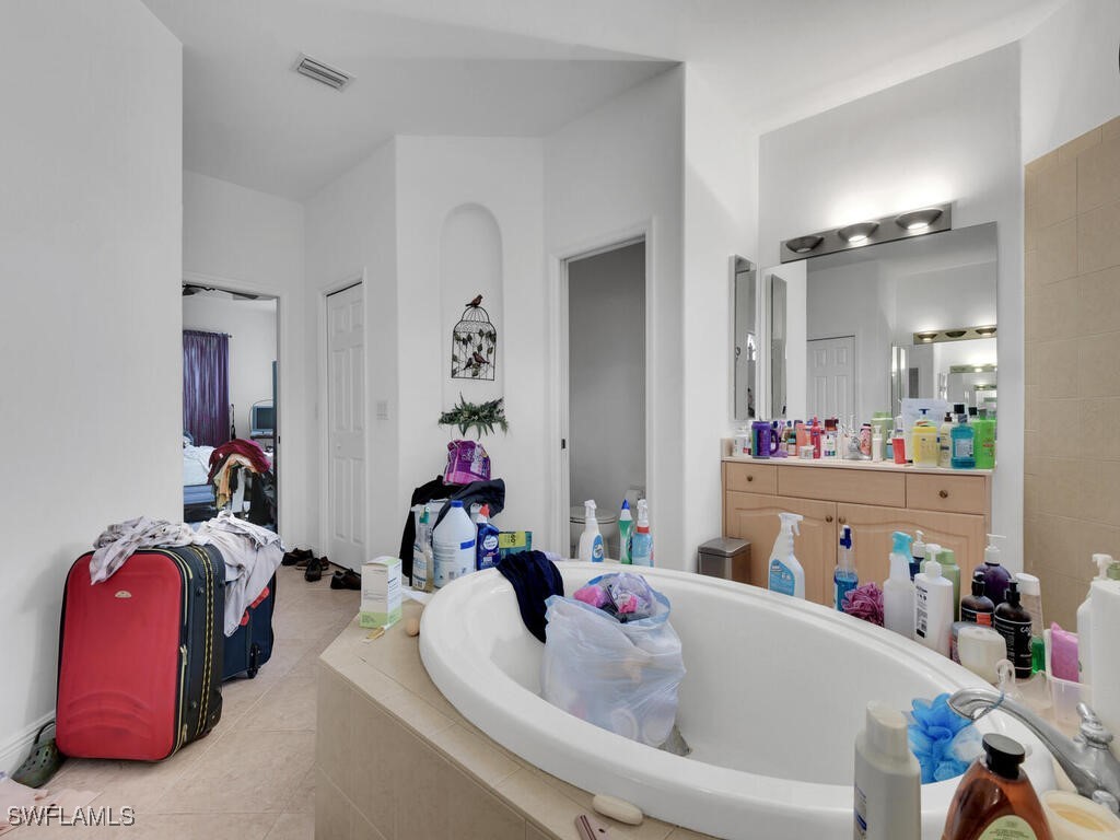 8123 Sandpiper Road Fort Myers, FL 33967 - Photo 14 of 23 a bathroom with a tub and mirror