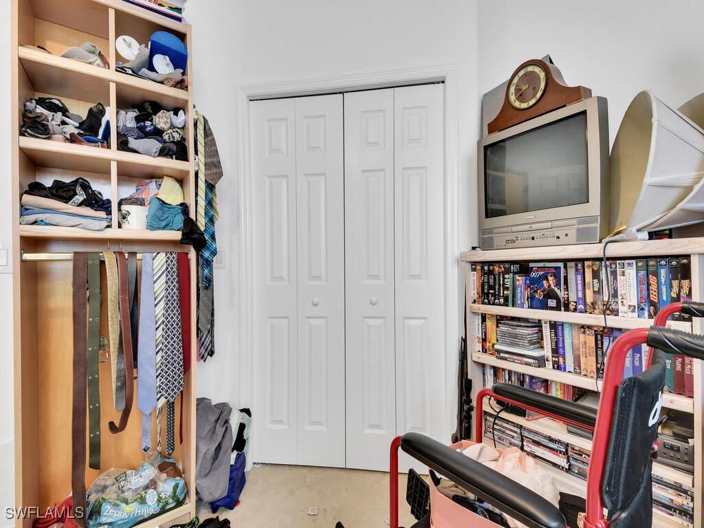 8123 Sandpiper Road Fort Myers, FL 33967 - Photo 20 of 23 a living room with lots of books and a book shelf
