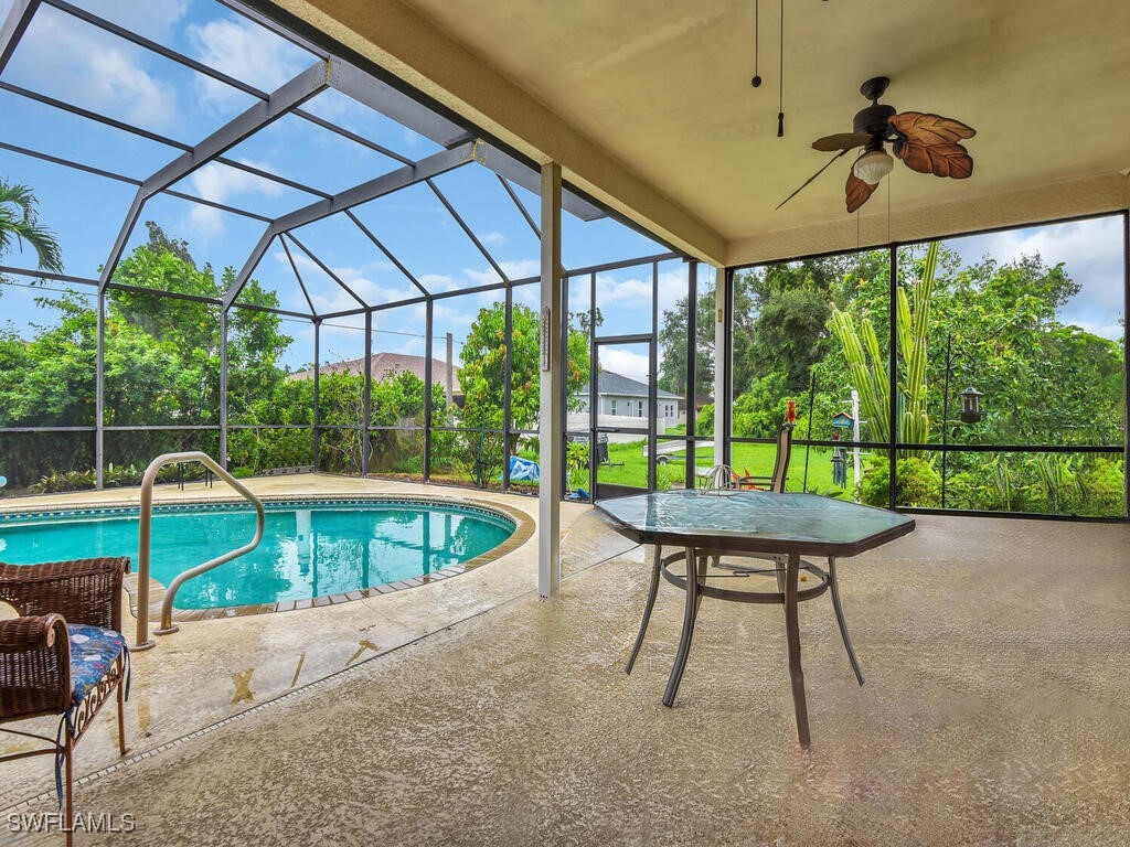 8123 Sandpiper Road Fort Myers, FL 33967 - Photo 22 of 23 a view of a patio with a table chairs and a backyard