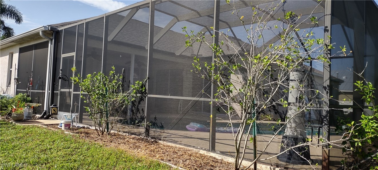 8123 Sandpiper Road Fort Myers, FL 33967 - Photo 5 of 23 a potted plant sitting in front of a house