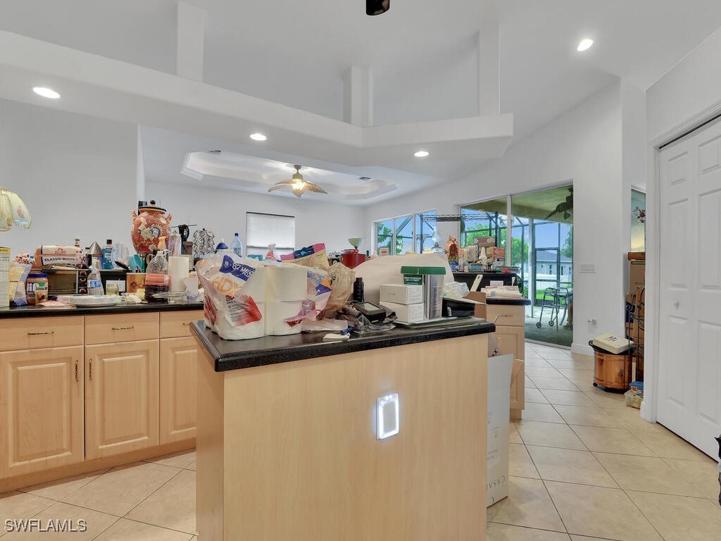 8123 Sandpiper Road Fort Myers, FL 33967 - Photo 7 of 23 a view of a kitchen with kitchen island a counter top space a sink a refrigerator and a view of living room