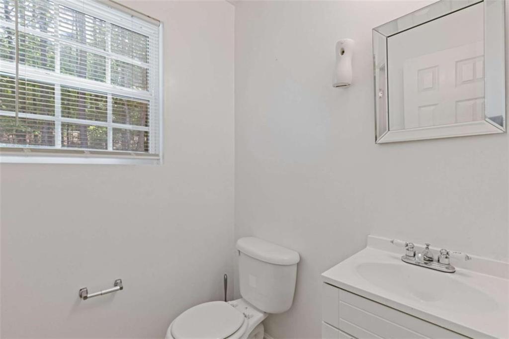 1450 Steam Engine Way Northeast Conyers, GA 30013 - Photo 11 of 33 a white toilet sitting next to a bathroom sink