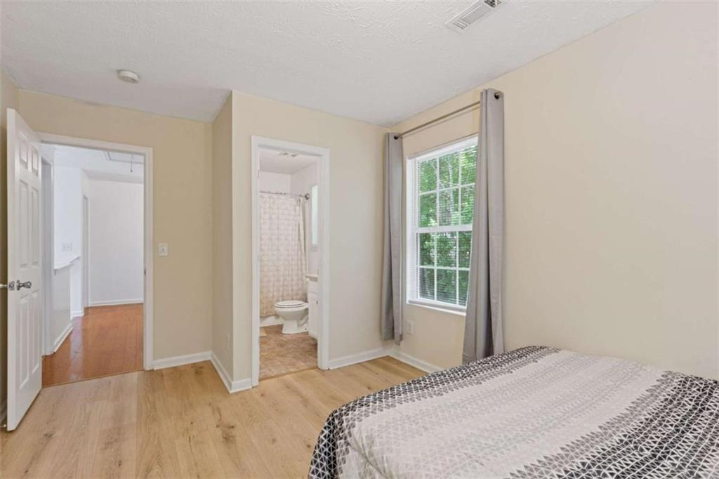 1450 Steam Engine Way Northeast Conyers, GA 30013 - Photo 13 of 33 a bedroom with a bed and a window