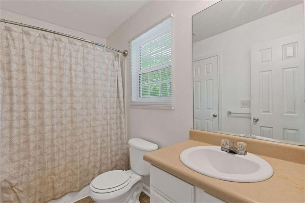 1450 Steam Engine Way Northeast Conyers, GA 30013 - Photo 14 of 33 a bathroom with a sink toilet and shower