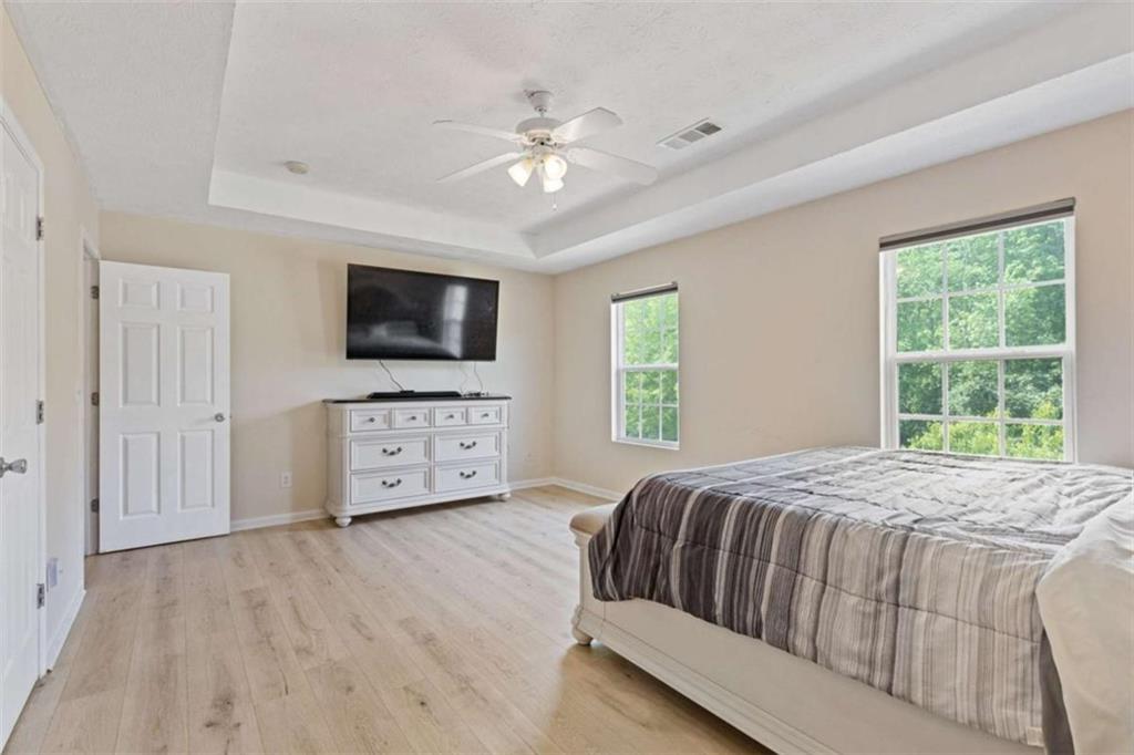 1450 Steam Engine Way Northeast Conyers, GA 30013 - Photo 18 of 33 a bedroom with a bed a window and a television