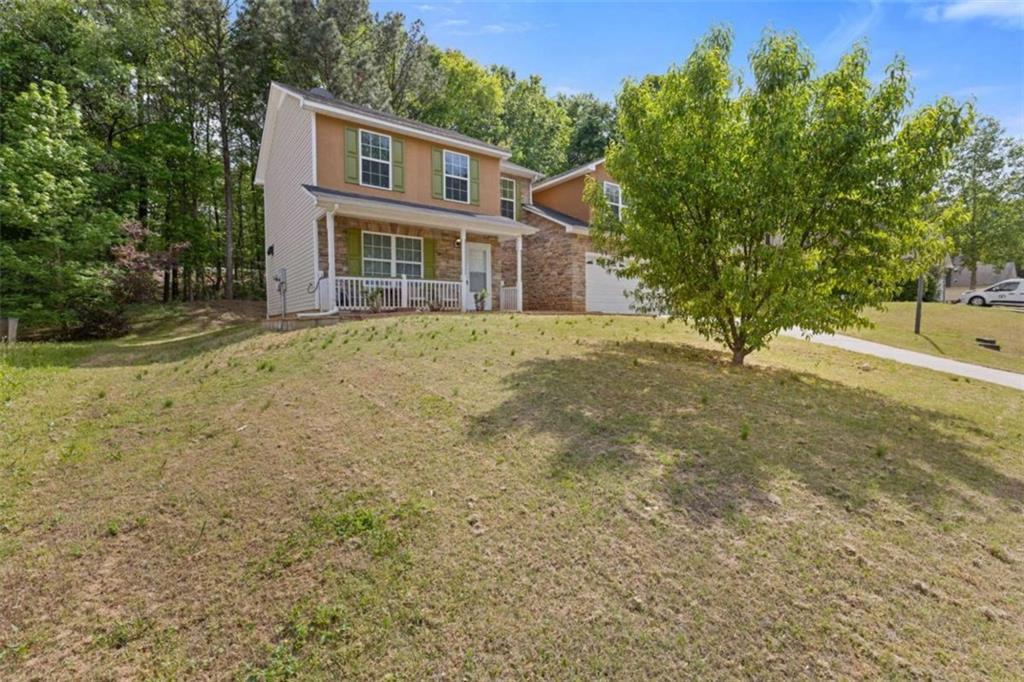 1450 Steam Engine Way Northeast Conyers, GA 30013 - Photo 2 of 33 a front view of a house with a garden
