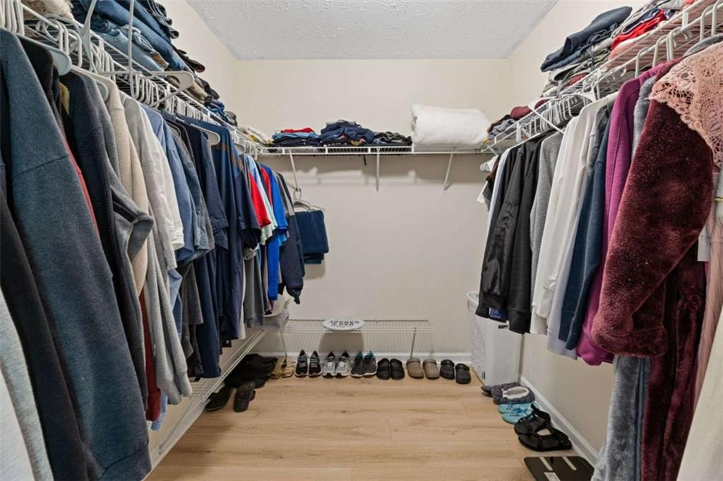 1450 Steam Engine Way Northeast Conyers, GA 30013 - Photo 21 of 33 a view of walk in closet with clothes and shoes