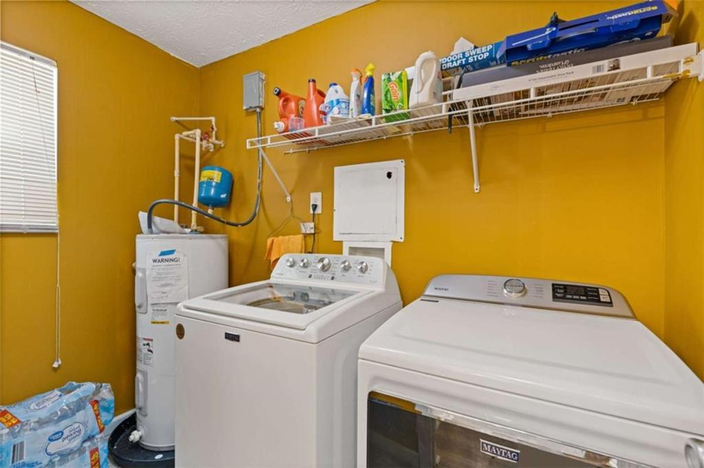 1450 Steam Engine Way Northeast Conyers, GA 30013 - Photo 22 of 33 a utility room with dryer and washer
