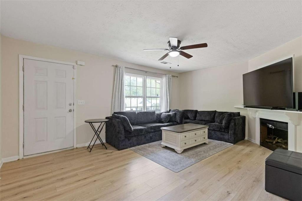 1450 Steam Engine Way Northeast Conyers, GA 30013 - Photo 6 of 33 a living room with furniture and a flat screen tv