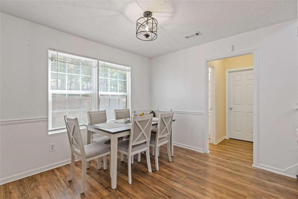 1450 Steam Engine Way Northeast Conyers, GA 30013 - Photo 10 of 33 a view of a dining room with furniture window and wooden floor