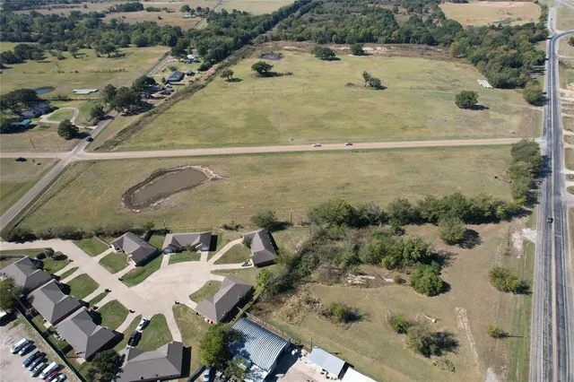 an aerial view of a house with a yard