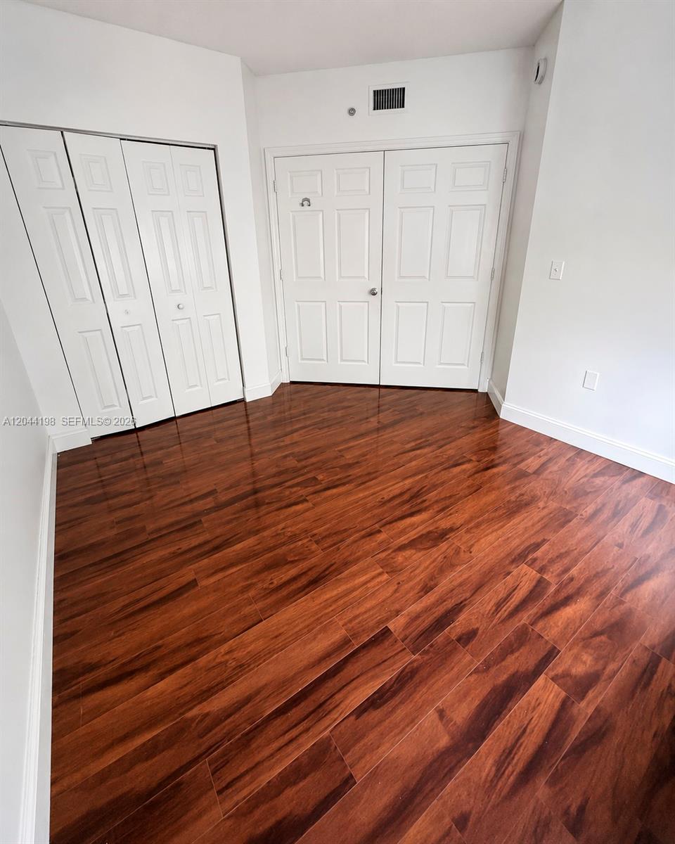 17145 North Bay Road, Unit 4307 Sunny Isles Beach, FL 33160 - Photo 20 of 35 a view of empty room with wooden floor