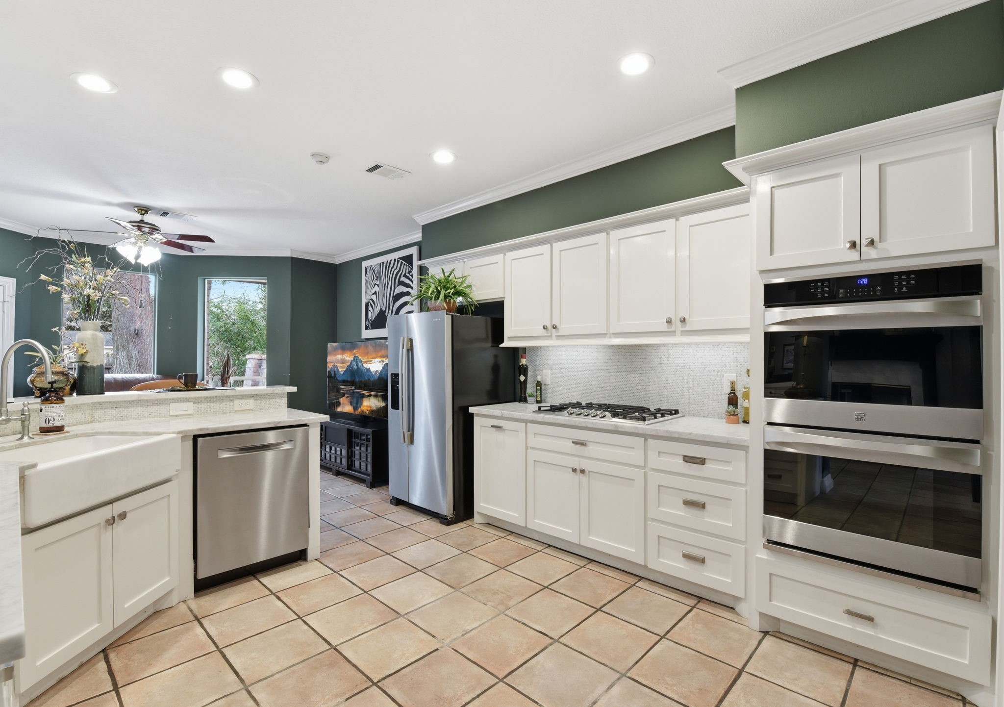 16322 Cranwood Drive Spring, TX 77379 - Photo 20 of 42 Discover culinary bliss in this kitchen, featuring a sleek double oven, efficient gas range, and charming farmhouse apron porcelain sink.