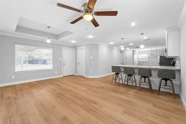a view of a dining room with furniture and a chandelier
