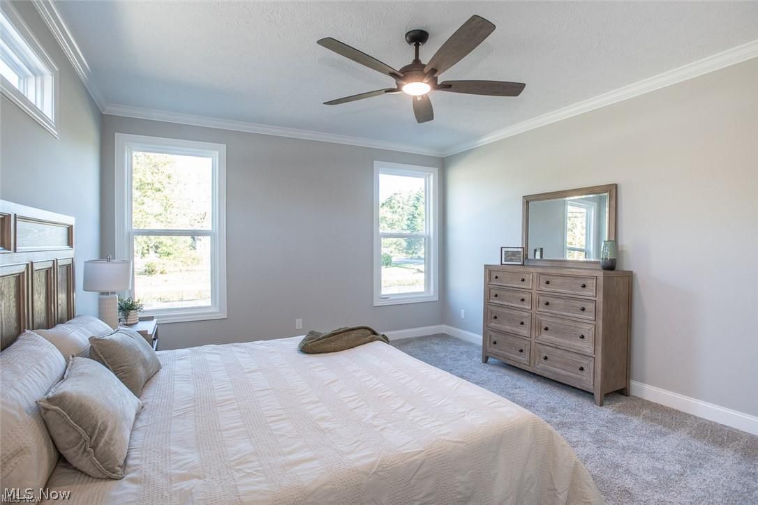 34286 Brookside Lane North Ridgeville, OH 44039 - Photo 22 of 50 Bedroom with ornamental molding, light carpet, a ceiling fan, and a textured ceiling