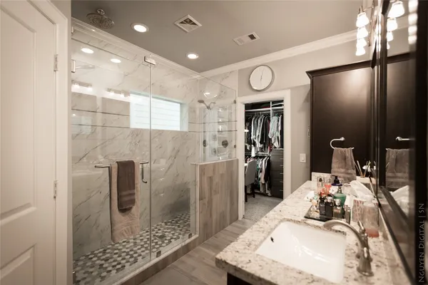 a bathroom with a sink a mirror and shower