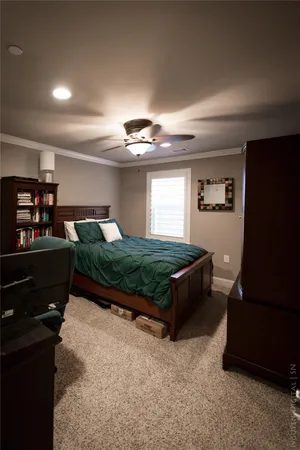 a bedroom with a large bed and a window