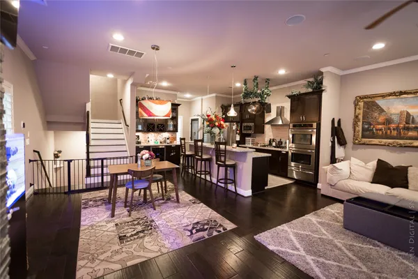 a living room with lots of furniture and kitchen view