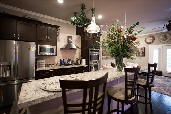 a kitchen with a table chairs stove and refrigerator