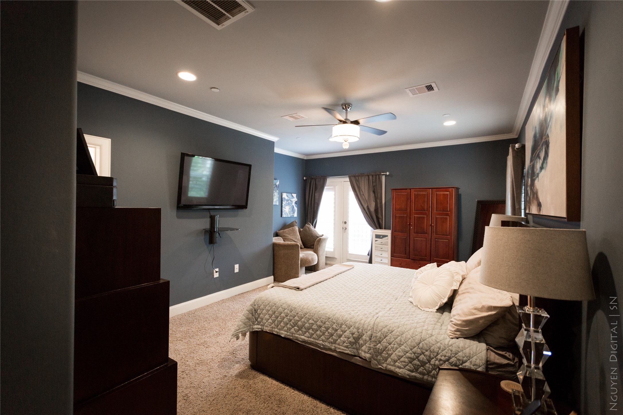1204 Cushing Street Houston, TX 77019 - Photo 9 of 26 a bedroom with a bed and a flat tv screen on dresser