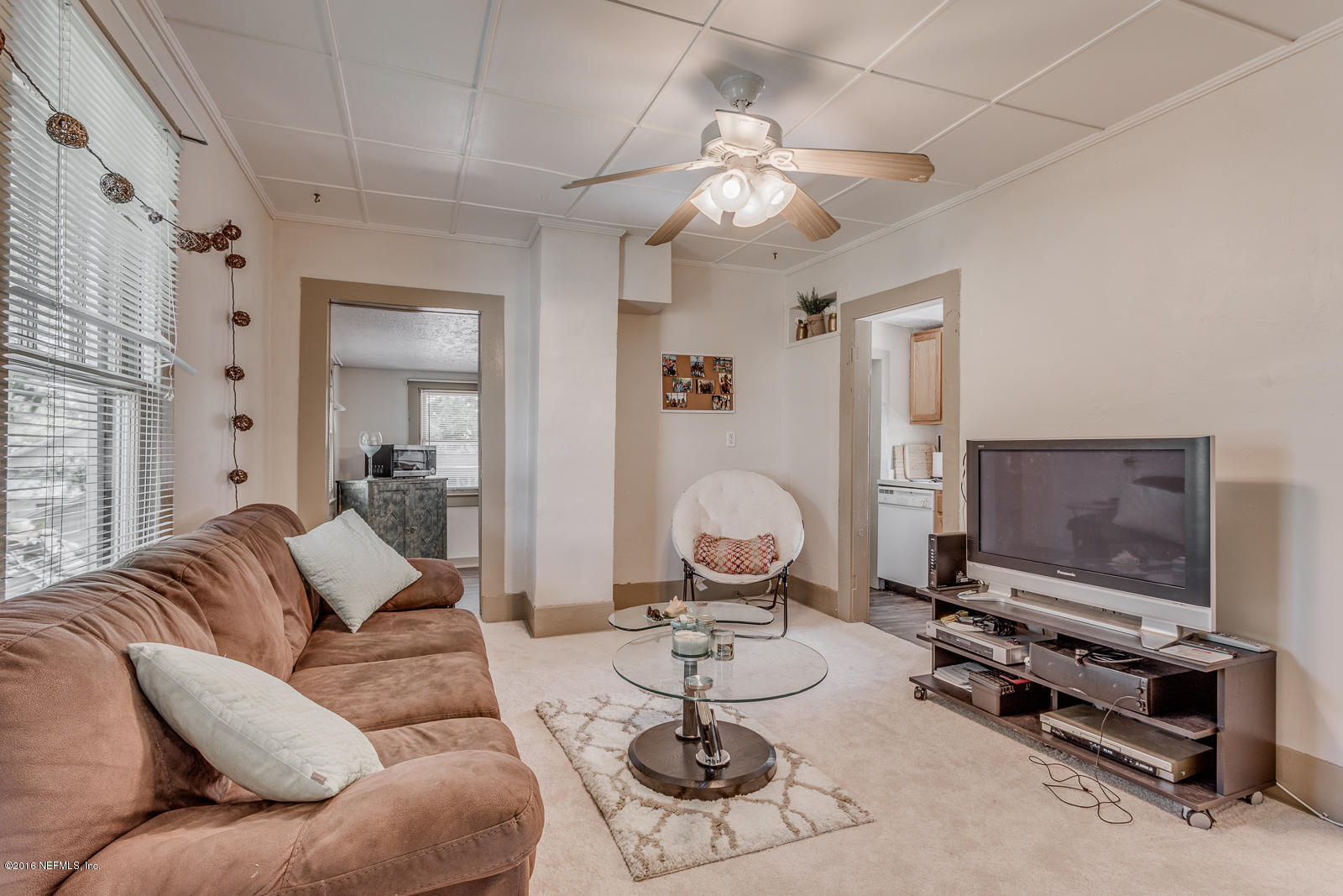 9 Riberia Street St. Augustine, FL 32084 - Photo 16 of 33 a living room with furniture a flat screen tv and gym equipment
