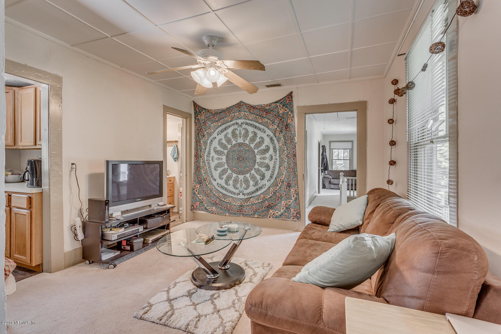 9 Riberia Street St. Augustine, FL 32084 - Photo 18 of 33 a living room with furniture a flat screen tv and a window