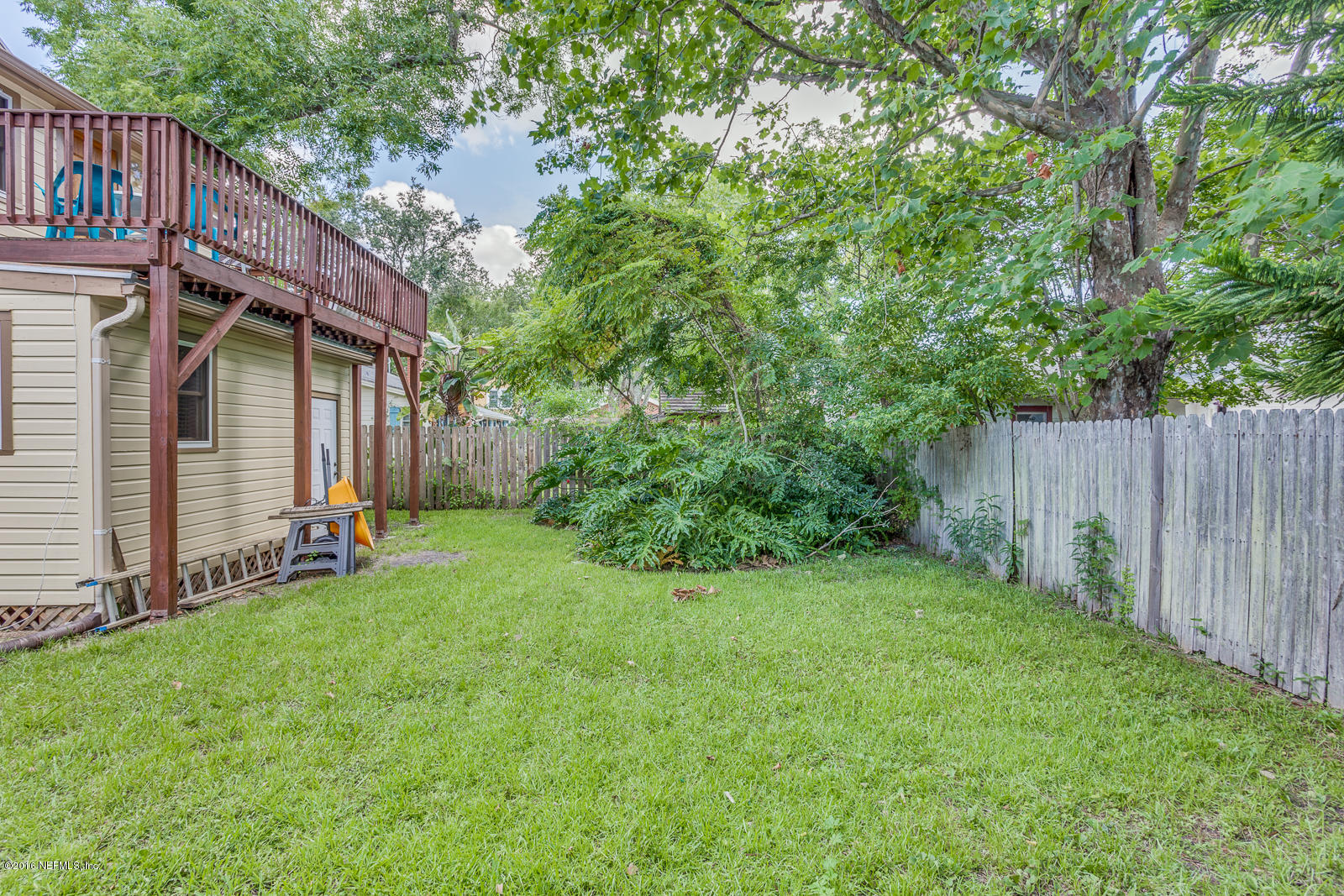 9 Riberia Street St. Augustine, FL 32084 - Photo 30 of 33 a view of a backyard with large trees and wooden fence