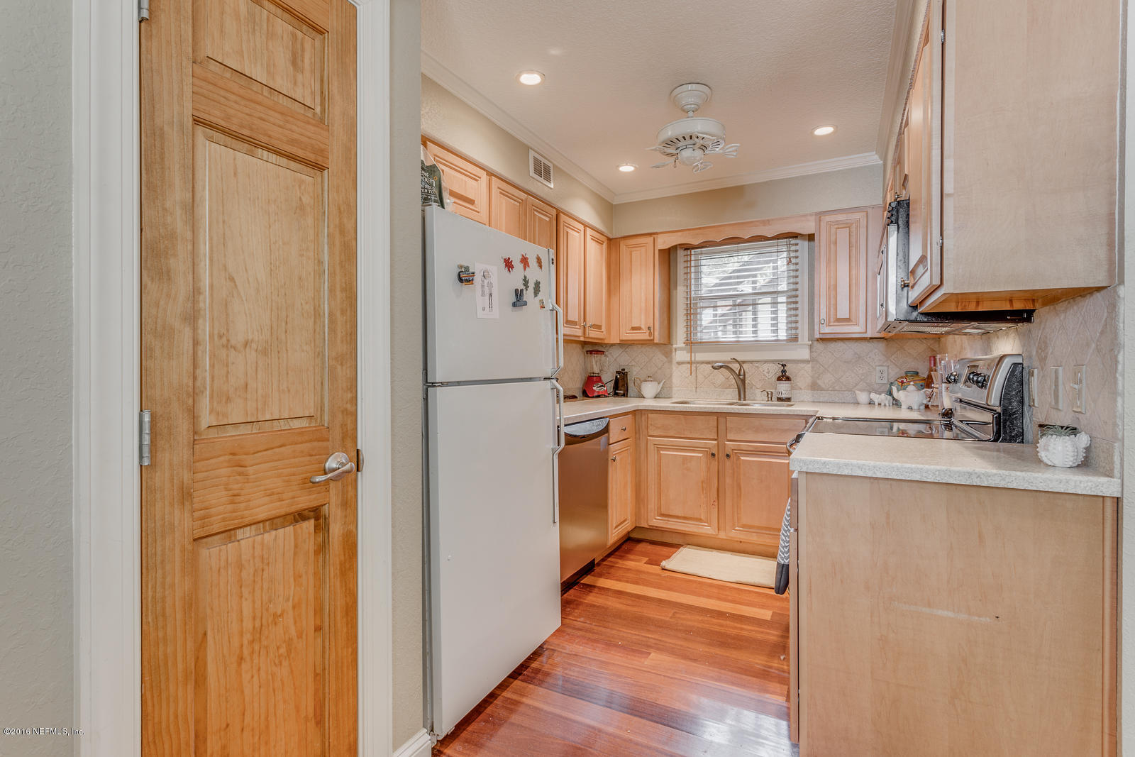 9 Riberia Street St. Augustine, FL 32084 - Photo 7 of 33 a kitchen with a refrigerator a sink and cabinets