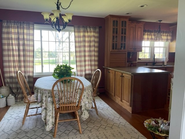 4059 Sunset Road Clinton, IL 61727 - Photo 11 of 55 a dining room with furniture a chandelier and window