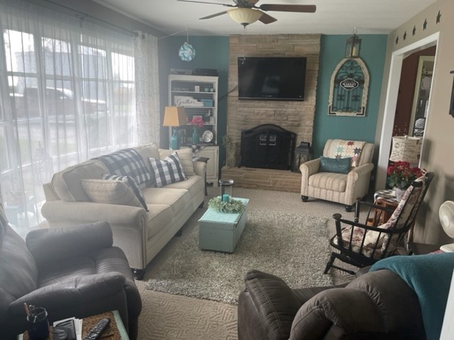 4059 Sunset Road Clinton, IL 61727 - Photo 21 of 55 a living room with furniture a flat screen tv and a fireplace