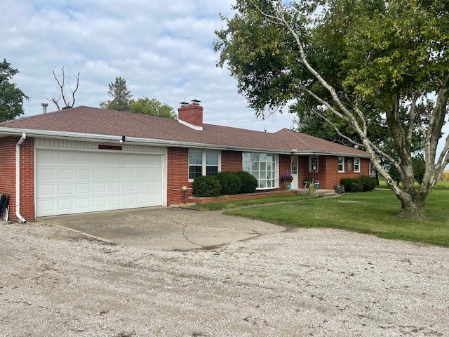 4059 Sunset Road Clinton, IL 61727 - Photo 3 of 55 a front view of a house with a yard and garage
