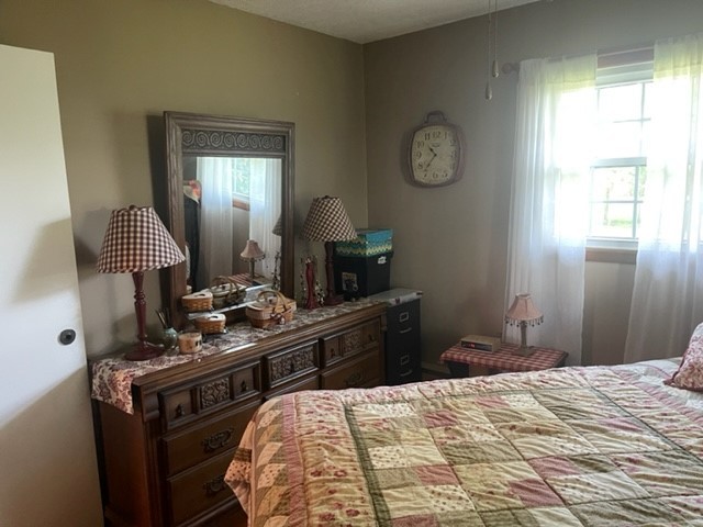 4059 Sunset Road Clinton, IL 61727 - Photo 32 of 55 a bedroom with a bed and a chandelier