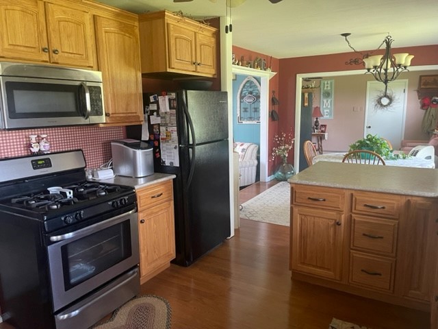 4059 Sunset Road Clinton, IL 61727 - Photo 8 of 55 a kitchen with stainless steel appliances granite countertop a stove a refrigerator and a microwave