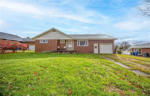 a front view of house with yard and green space