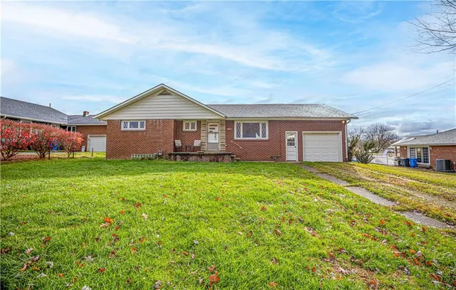 a front view of house with yard and green space