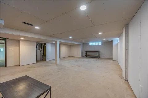 a view of a house with a backyard and a chair