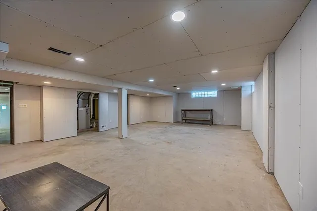 a view of a house with a backyard and a chair