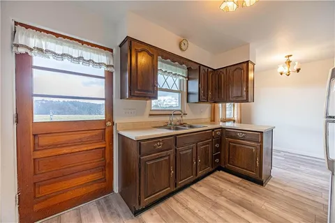 a kitchen with stainless steel appliances granite countertop a sink and cabinets