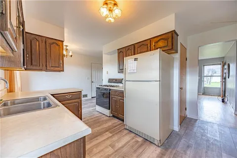 a kitchen with a refrigerator sink and stove