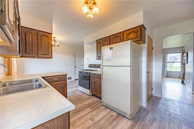 a kitchen with a refrigerator sink and stove