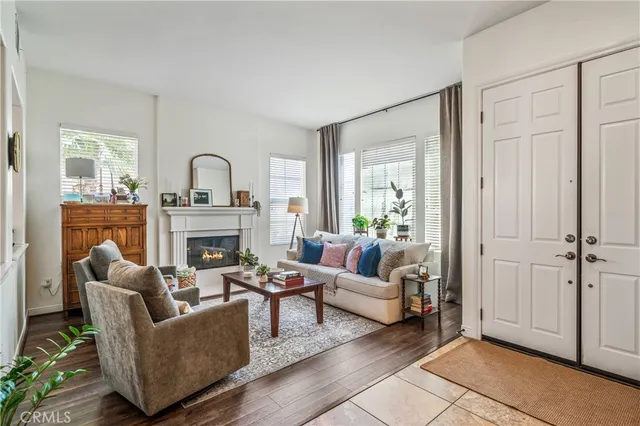 a living room with fireplace furniture and a window
