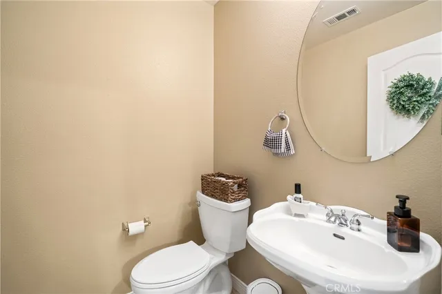 a bathroom with a sink vanity granite and a mirror