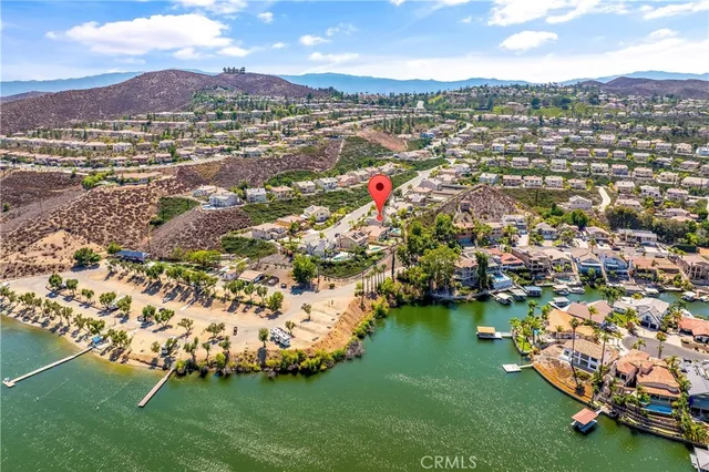 an aerial view of residential houses with outdoor space and trees