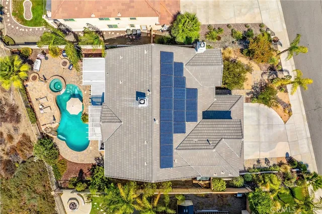 a aerial view of a house with a yard and table and chairs