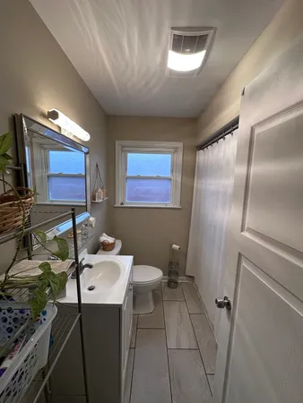 a bathroom with a sink toilet and mirror