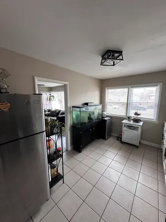 a kitchen with stainless steel appliances kitchen island granite countertop a refrigerator and a sink