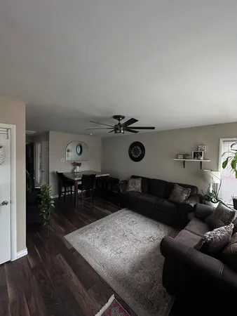 a living room with furniture and wooden floor