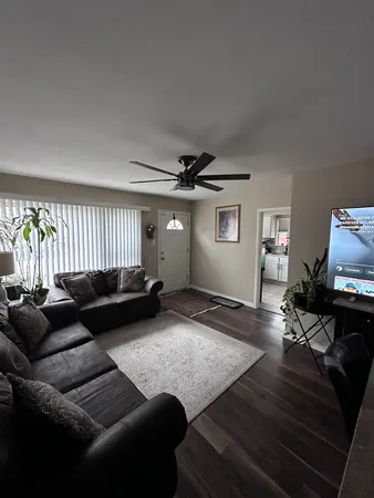 a living room with furniture and wooden floor