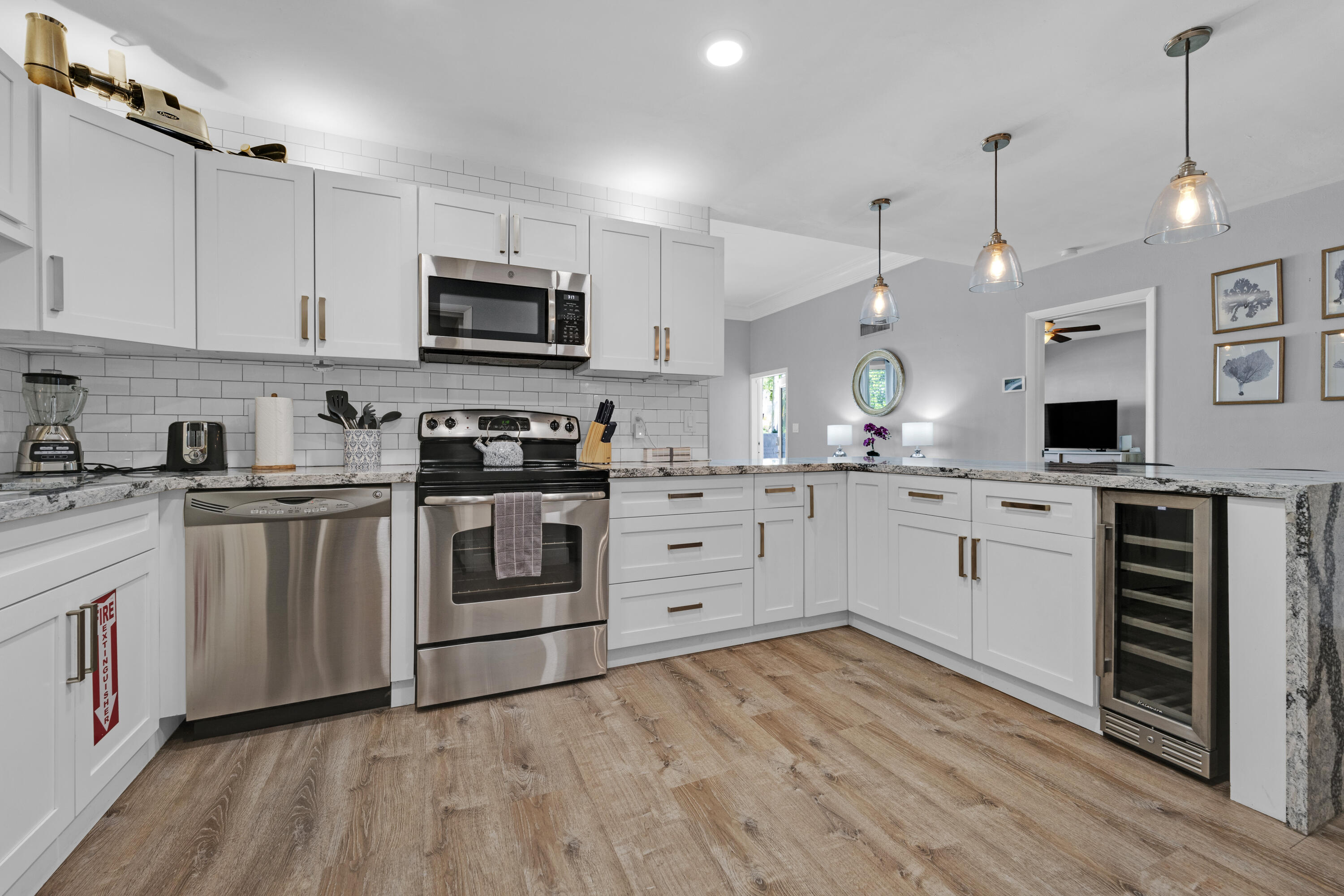 a kitchen with white cabinets stainless steel appliances and sink